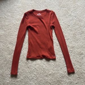 XS, this long sleeved shirt can stretch, the color is also a dark orange